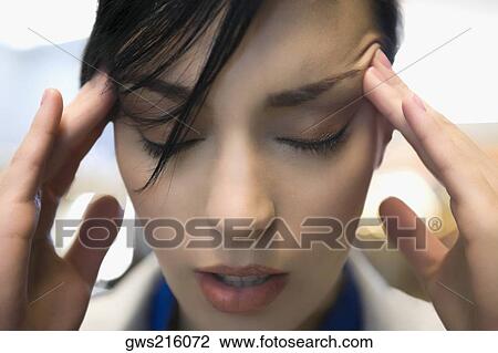 Close-up of a businesswoman suffering from a headache View Large Photo Image Stock Image - Close-up of a businesswoman suffering from a headache. Fotosearch