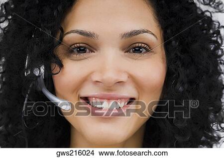 Close-up of a female customer service representative wearing a headset View Large Photo Image Picture - Close-up of a female customer service representative wearing a headset. Fotosearch