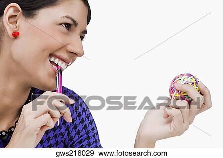 Close-up of a young woman holding rubber bands and smiling View Large Photo Image Stock Photo - Close-up of a young woman holding rubber bands and smiling. Fotosearch