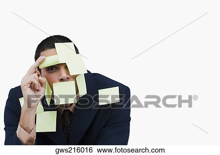 Stock Photograph - Portrait of a businessman covered with adhesive notes. Fotosearch