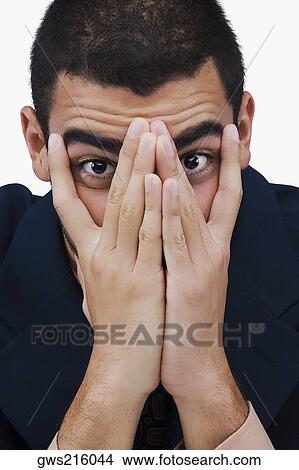 Picture - Portrait of a businessman covering his face with his hands. Fotosearch