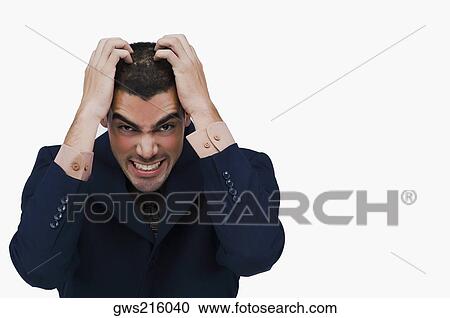Stock Image - Portrait of a businessman holding his head. Fotosearch