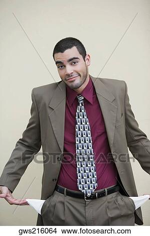 Portrait of a businessman showing out his empty pockets View Large Photo Image Picture - Portrait of a businessman showing out his empty pockets. Fotosearch