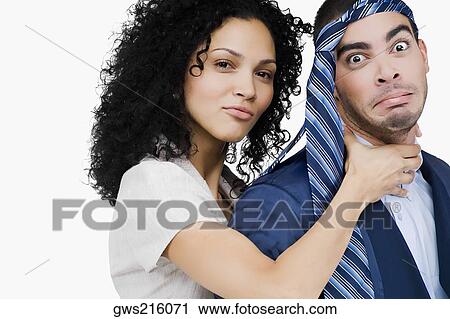 Stock Image - Portrait of a businesswoman pretending to strangulate a businessman. Fotosearch