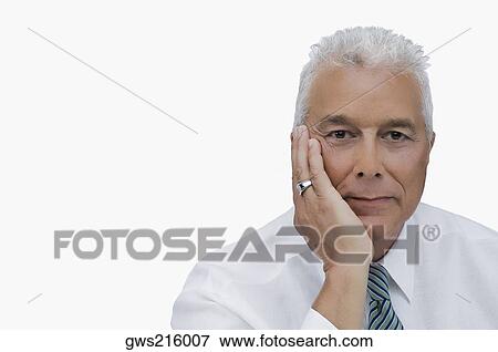 Portrait of a senior man thinking with his hand on his chin View Large Photo Image Stock Photo - Portrait of a senior man thinking with his hand on his chin. Fotosearch
