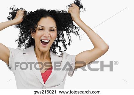 Stock Image - Portrait of a young woman holding her hair. Fotosearch