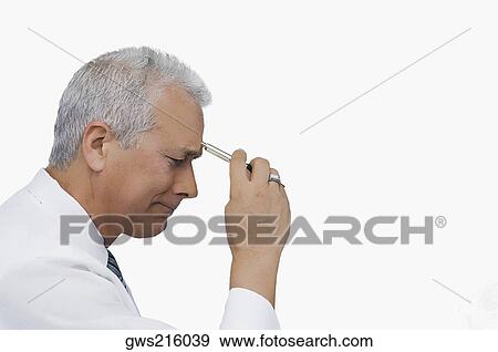 Stock Photo - Side profile of a businessman holding a pen and thinking. Fotosearch