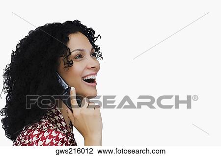 Stock Image - Side profile of a businesswoman using a mobile phone. Fotosearch