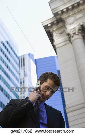 Businessman talking on a mobile phone View Large Photo Image Stock Image - Businessman talking on a mobile phone. Fotosearch