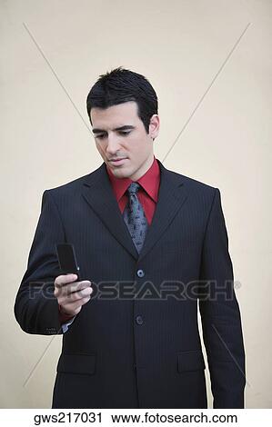 Businessman using a mobile phone View Large Photo Image Stock Image - Businessman using a mobile phone. Fotosearch