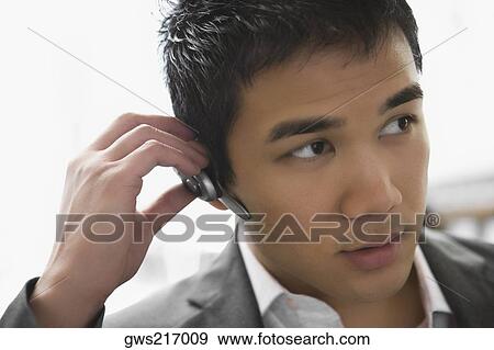 Close-up of a businessman wearing a hands free device View Large Photo Image Stock Photo - Close-up of a businessman wearing a hands free device. Fotosearch
