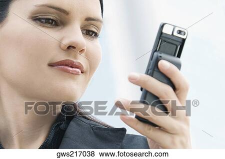 Close-up of a businesswoman text messaging View Large Photo Image Stock Photo - Close-up of a businesswoman text messaging. Fotosearch