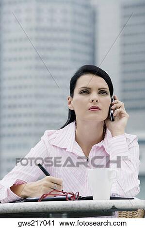 Stock Image - Close-up of a businesswoman using a mobile phone. Fotosearch