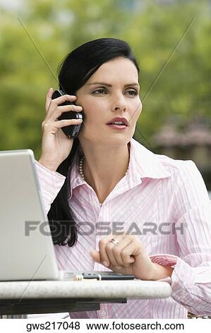 Close-up of a businesswoman using a mobile phone View Large Photo Image Stock Photo - Close-up of a businesswoman using a mobile phone. Fotosearch