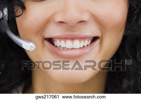 Close-up of a customer service representative smiling View Large Photo Image Stock Image - Close-up of a customer service representative smiling. Fotosearch