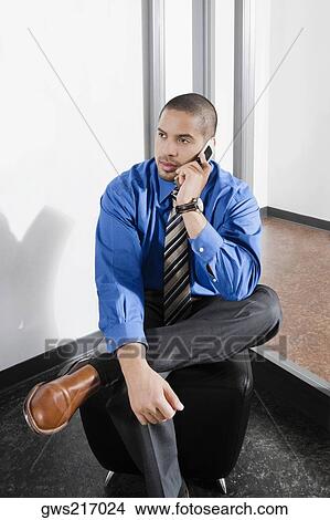Mid adult man talking on a mobile phone View Large Photo Image Picture - Mid adult man talking on a mobile phone. Fotosearch