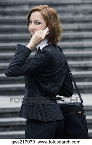Portrait of a businesswoman talking on a mobile phone and smiling View Large Photo Image Stock Image - Portrait of a businesswoman talking on a mobile phone and smiling. Fotosearch
