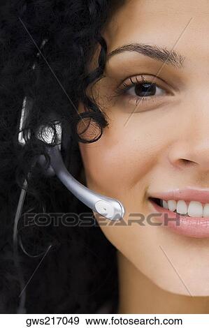 Portrait of a female customer service representative wearing a headset View Large Photo Image Stock Photo - Portrait of a female customer service representative wearing a headset. Fotosearch