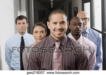 Stock Photo - Business executives standing in a corridor. Fotosearch
