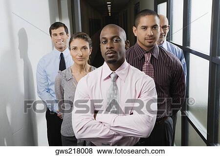 Business executives standing in a corridor View Large Photo Image Stock Photo - Business executives standing in a corridor. Fotosearch