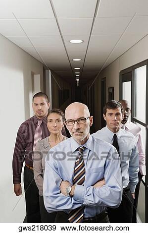 Stock Photo - Business executives standing in a corridor. Fotosearch