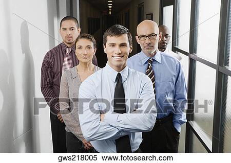 Stock Photography - Business executives standing in a corridor. Fotosearch