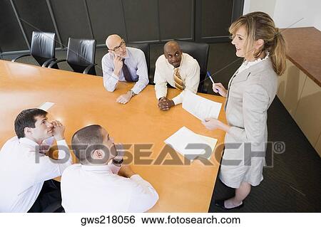 Businesswoman giving a presentation in a board room View Large Photo Image Stock Photograph - Businesswoman giving a presentation in a board room. Fotosearch