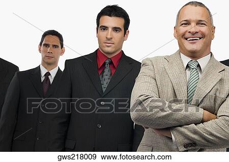 Portrait of a businessman smiling and three businessmen standing behind him View Large Photo Image Stock Photo - Portrait of a businessman smiling and three businessmen standing behind him. Fotosearch