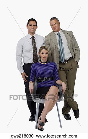 Portrait of a businesswoman sitting on a chair with two businessmen standing behind her View Large Photo Image Stock Image - Portrait of a businesswoman sitting on a chair with two businessmen standing behind her. Fotosearch
