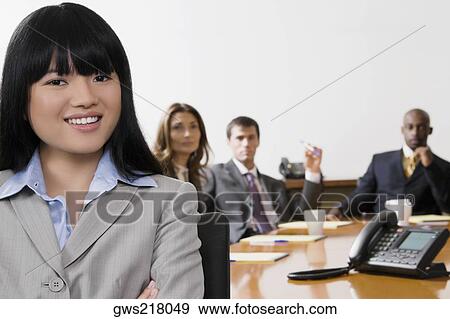 Portrait of a businesswoman with her colleagues in the background View Large Photo Image Stock Photo - Portrait of a businesswoman with her colleagues in the background. Fotosearch