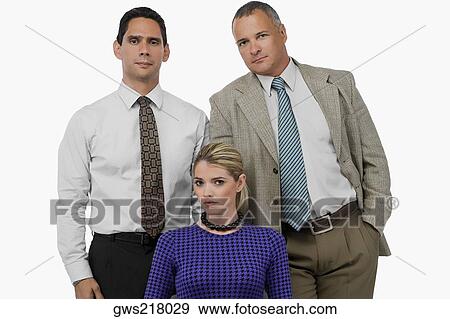 Portrait of a businesswoman with two businessmen standing behind her View Large Photo Image Stock Photo - Portrait of a businesswoman with two businessmen standing behind her. Fotosearch