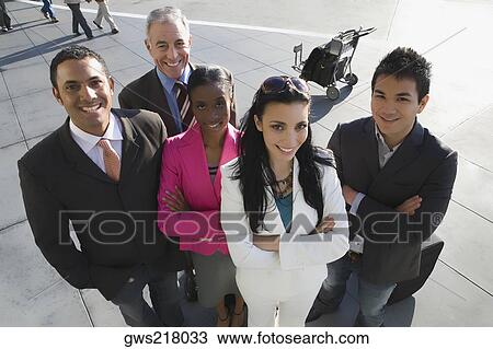 Portrait of two businesswomen with three businessmen standing and smiling together View Large Photo Image Stock Image - Portrait of two businesswomen with three businessmen standing and smiling together. Fotosearch