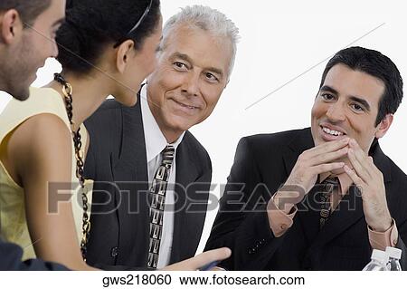 Three businessmen and a businesswoman at a meeting in a conference room View Large Photo Image Stock Image - Three businessmen and a businesswoman at a meeting in a conference room. Fotosearch