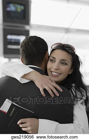 Close-up of a businesswoman hugging a businessman at an airport View Large Photo Image Stock Photograph - Close-up of a businesswoman hugging a businessman at an airport. Fotosearch