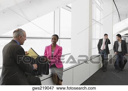 Stock Photo - Four business executives at an airport. Fotosearch