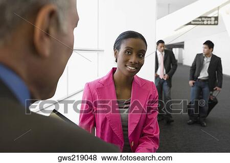 Four business executives at an airport View Large Photo Image Stock Photo - Four business executives at an airport. Fotosearch