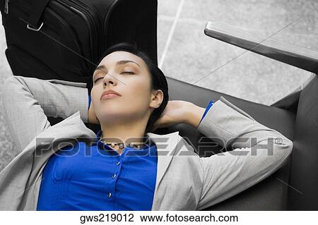 Stock Image - High angle view of a businesswoman sleeping. Fotosearch