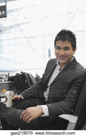Portrait of a businessman holding a disposable glass View Large Photo Image Stock Image - Portrait of a businessman holding a disposable glass. Fotosearch
