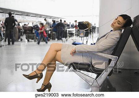 Side profile of a businesswoman sleeping on a chair at an airport View Large Photo Image Stock Image - Side profile of a businesswoman sleeping on a chair at an airport. Fotosearch