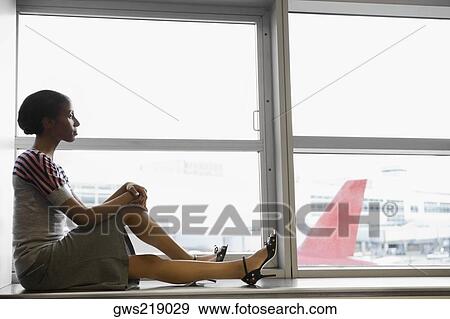 Side profile of a businesswoman waiting in a waiting room at an airport View Large Photo Image Stock Photo - Side profile of a businesswoman waiting in a waiting room at an airport. Fotosearch