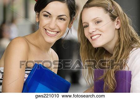 Close-up of female university students smiling View Large Photo Image Stock Image - Close-up of female university students smiling. Fotosearch