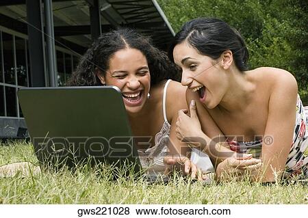 Female university students working on a laptop and laughing View Large Photo Image Stock Photo - Female university students working on a laptop and laughing. Fotosearch