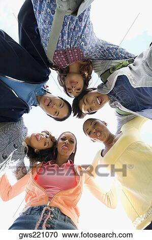 Low angle view of university students standing in a huddle View Large Photo Image Stock Image - Low angle view of university students standing in a huddle. Fotosearch