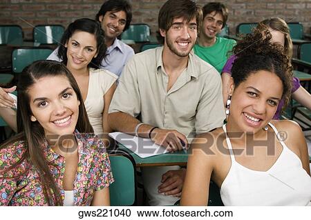 Portrait of university students sitting in a classroom and smiling View Large Photo Image Stock Image - Portrait of university students sitting in a classroom and smiling. Fotosearch