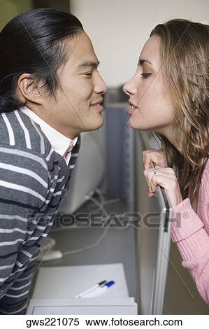 Side profile of a young couple romancing in a computer lab View Large Photo Image Stock Photography - Side profile of a young couple romancing in a computer lab. Fotosearch