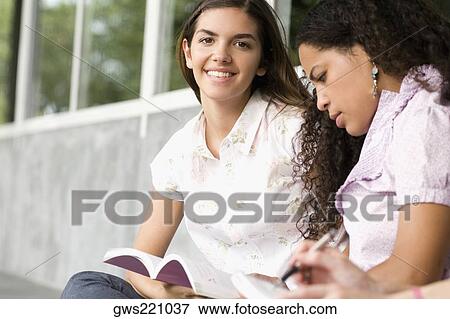 Stock Photo - Two university students studying in a corridor. Fotosearch