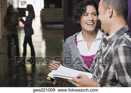 Two university students talking in a corridor View Large Photo Image Stock Photo - Two university students talking in a corridor. Fotosearch