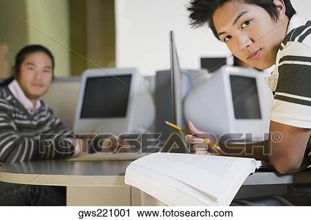 Two young men studying in a computer lab View Large Photo Image Stock Image - Two young men studying in a computer lab. Fotosearch