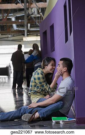 Young couple romancing in a corridor View Large Photo Image Stock Photo - Young couple romancing in a corridor. Fotosearch