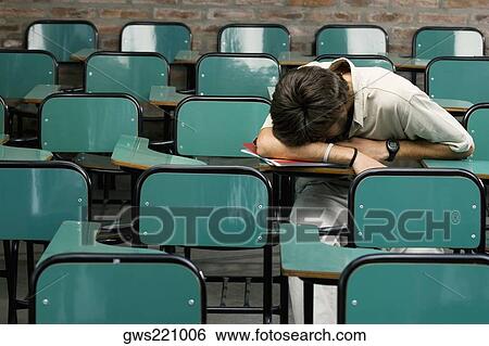 Stock Photograph - Young man napping in a classroom. Fotosearch